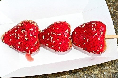 3 candied strawberries in white paper tray